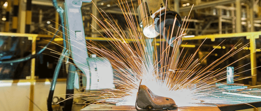 CNC Welding Machine in a factory setting with sparks flying