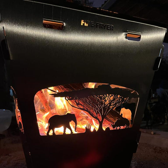 Stainless steel braai being used with firewood
