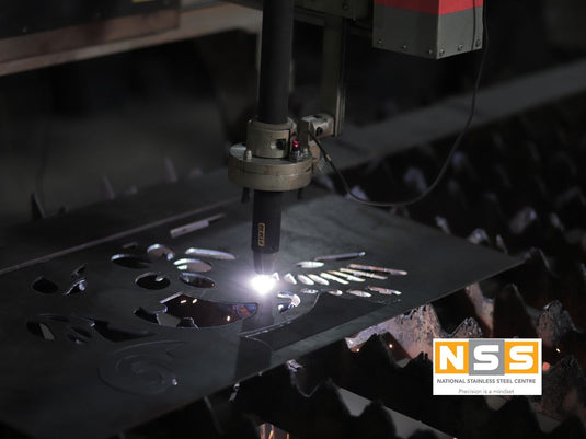 Plasma cutting torch cutting a stainless steel plate